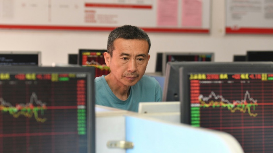 China halves stock trade tax to boost market