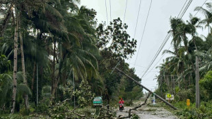 Floods strand people on roofs as typhoon pounds Philippines