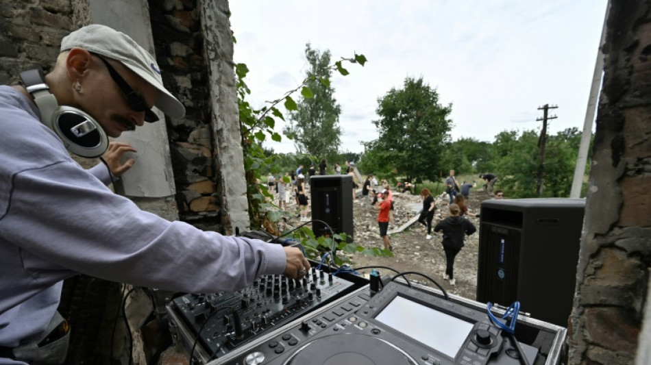 Ukrainian partygoers help clear away ruins of war