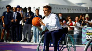 Macron takes to wheelchair to urge French to support 2024 Paralympics