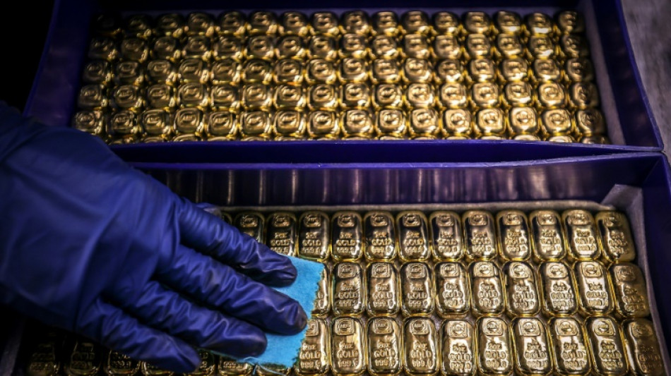 Gold hits record, dollar drops as tariff fears dampen sentiment